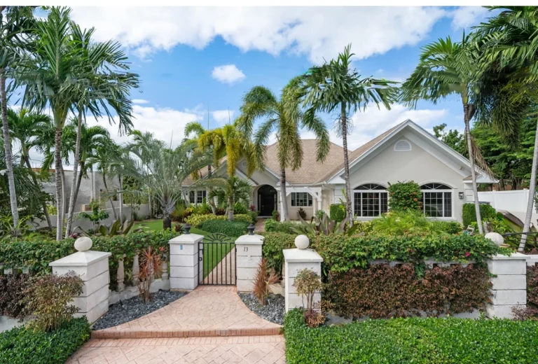 Gated entrance with gardens at Hightides, Nassau