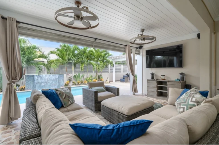 Outdoor lounge with sectional and pool view at Hightides, Nassau