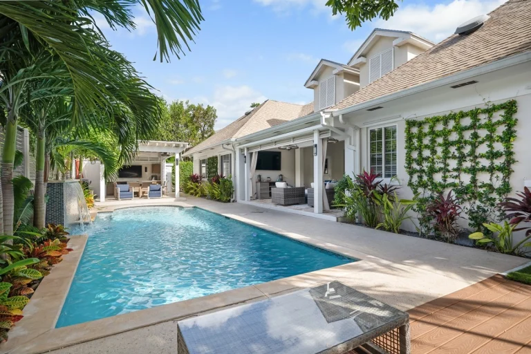 Pool with green wall and patio at Hightides, Nassau