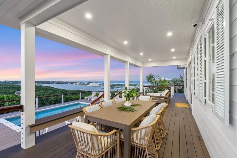 Covered deck with dining table and pool view at Incommunicado, Hope Town, Elbow Cay