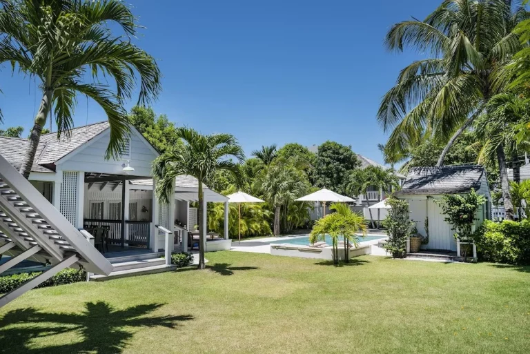 Cottage with lawn and pool beyond at Java Cottage, Dunmore Town, Harbour Island