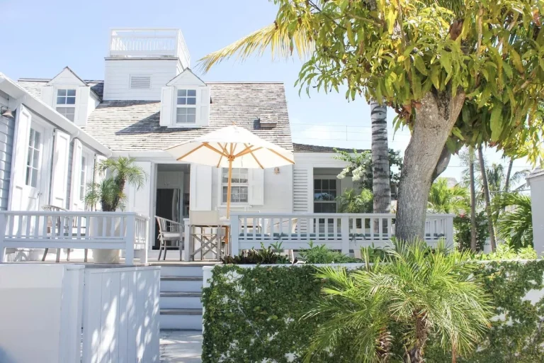 House with balcony and umbrella at Java Cottage, Dunmore Town, Harbour Island