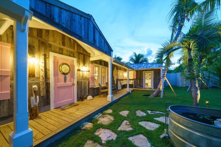 Front porch with pink door and stepping-stone path at Surf Shack, Dunmore Town, Harbour Island