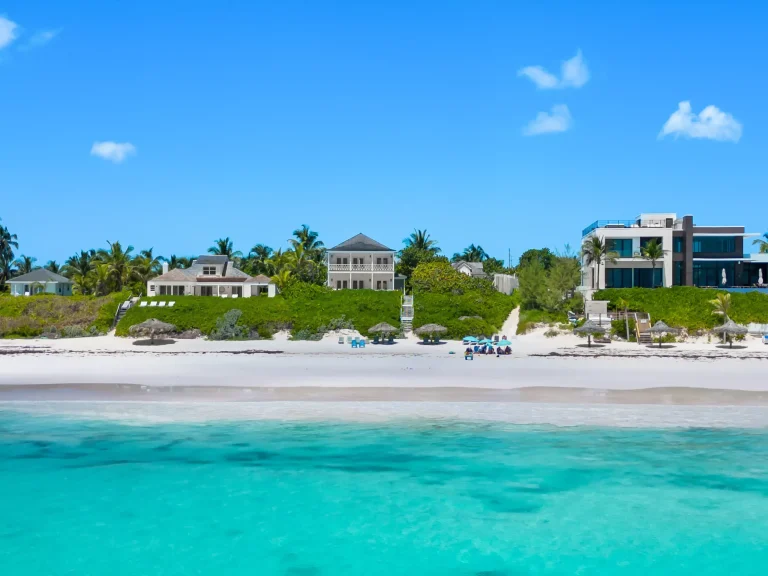 Beach and turquoise water with the house beyond at Sea Siren, Dunmore Town, Harbour Island