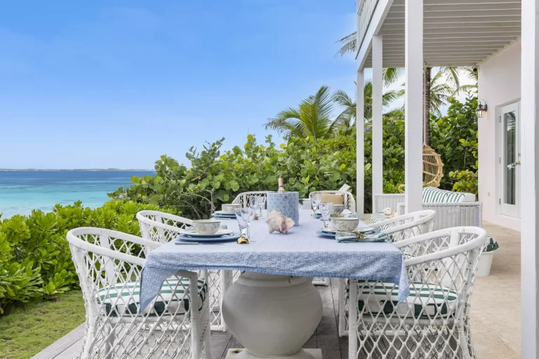 Outdoor dining table with ocean view at Sea Siren, Dunmore Town, Harbour Island