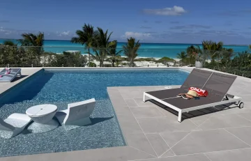 Pool with in-water loungers and ocean view at Beyond Blue Exuma, Moss Town, Great Exuma
