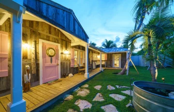 Front porch with pink door and stepping-stone path at Surf Shack, Dunmore Town, Harbour Island