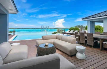 Deck lounge with sofas and pool view at Villa Exuma, Hartswell, Great Exuma